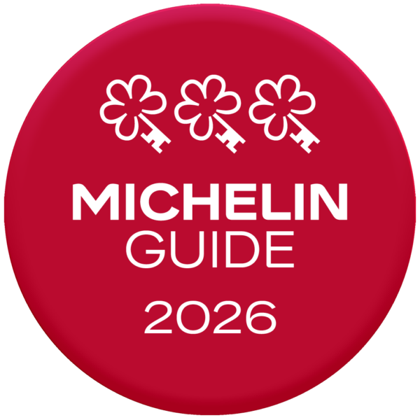 Red circle displaying three key icons at the top reading, "MICHELIN GUIDE 2026", indicating a Three MICHELIN Key recognition.