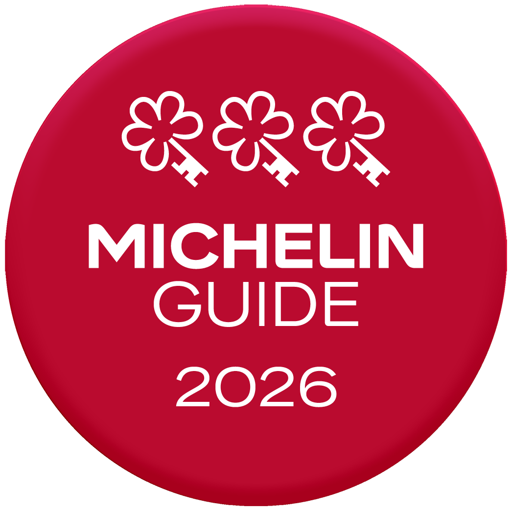 Red circle displaying three key icons at the top reading, "MICHELIN GUIDE 2026", indicating a Three MICHELIN Key recognition.